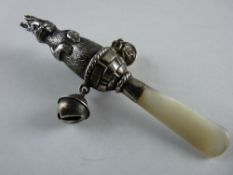 A SILVER BABY'S RATTLE with mother of pearl handle fashioned as a double sided rabbit standing in