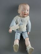 A KAMMER & REINHARDT BISQUE HEADED BOY DOLL, head to the right, blue fixed eyes and open mouth, in a