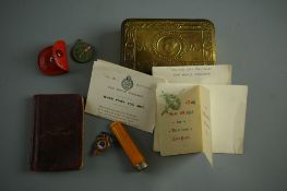 A WORLD WAR I CHRISTMAS TIN & CONTENTS including a 1915 card 'From Princess Mary & Friends at Home',