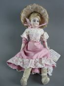 A SIMON & HALBIG BISQUE HEADED WALKING DOLL with open eyes, pink silk and lace dress with bonnet, 28