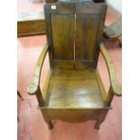 AN ANTIQUE OAK BOX SEAT ARMCHAIR with panel back and shaped apron, 101 cms high, 61 cms wide (