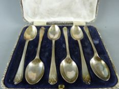 A CASED SET OF SIX SILVER TEASPOONS with raised golf club decoration to handle, Walker & Hall,
