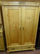 A VINTAGE FRENCH STYLE PINE TWO DOOR ARMOIRE with single lower drawer raised on bun feet, having