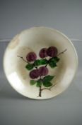 A LLANELLY PLUM DECORATED SHALLOW DISH, 25 cms diameter with Llanelly backstamp (kiln