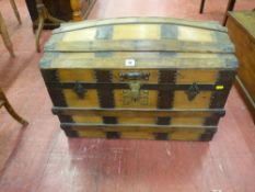 A WOODEN DOME TOPPED TRUNK with iron work strapping and brass lock, 51 cms high, 71.5 cms wide, 41