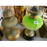 Victorian oil lamp with green glass font and a similarly styled brass example