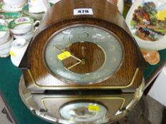 Vintage oak cased mantel clock and a small oval bevelled edge mirror