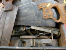 Vintage wooden toolbox containing block planes and a quantity of vintage hand saws