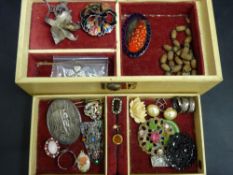 Quantity of vintage costume jewellery in a musical box