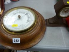Mantel clock by Record and a wall barometer