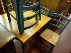 Modern green painted dining set of light wood top draw leaf table and four rush seated chairs