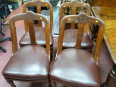 Set of four late Victorian salon chairs with carved detail and leather effect seats, on turned front