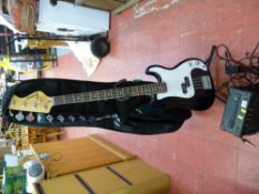 Electric bass guitar and stand and a small portable lamp E/T