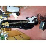 Electric bass guitar and stand and a small portable lamp E/T