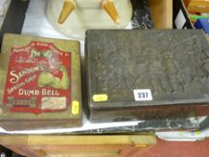 Vintage embossed tin and pair of Sandos spring grip dumb bells in original container