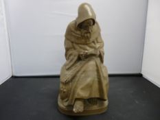 Carved soapstone figure of a seated friar reading a book