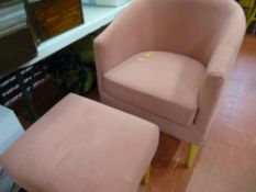 Salmon coloured upholstered tub chair and matching footstool