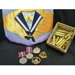 Two unmarked 1939-1945 war medals, three cap badges, quantity of clean spent bullet casings 1940's