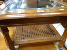 Glass topped Long John table with cane lower shelf