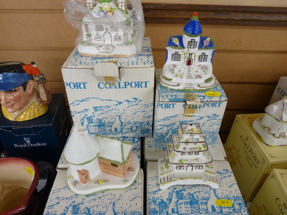 Seven boxed Coalport cottages