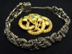 Serpent style pinchbeck brooch with five oblong cut decorative green stones and an oblong floral