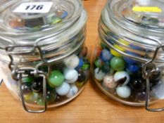 Two lidded glass jars with marble contents