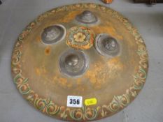 Painted hide circular shield with white metal mounts