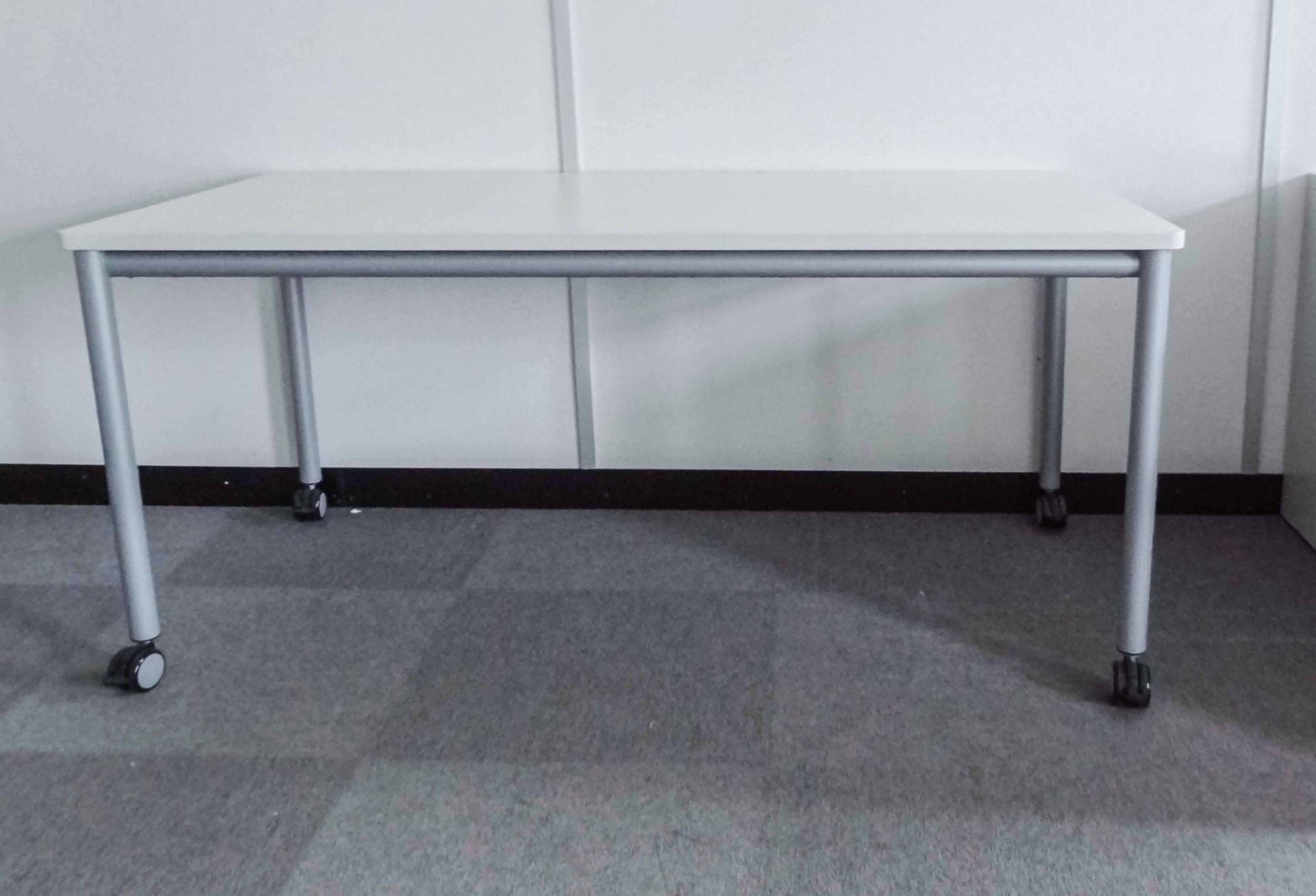 Three Mobile Office Tables, with braking castors, white laminate top with rounded corners and silver