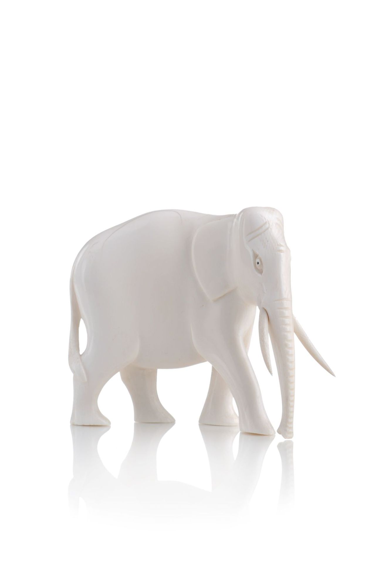 Asiatischer Elefant. Frühes 20. Jh. Elfenbein, geschnitzt und poliert. Unsigniert.Ein Stoßzahn neu