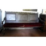 An 18th Century Oak Bench/Settle with triple fielded panel back and carved top rail, and shaped side