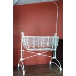 A Victorian Cast Iron and Metal Swing Crib, finished in gloss white.