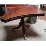 A Regency Tilt Top table with an unusual shaped top with a turned column support and tripod base