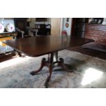 A Good Regency Mahogany Breakfast Table, the rectangular tilt top with reeded edge raised on a