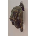 BEDROOM 8: A Brass Door Knocker in the shape of a hound's head, of neat proportions.