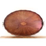 An Oval Georgian Mahogany Serving Tray with wavy edge border, central conch shell inlaid detail