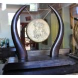 A Brass Dinner Gong having a hardwood horn shaped frame and stand. 17.5in (h).