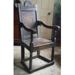 A Late 17th/Early 18th Century Elm Elbow Chair, having foliate and carved cresting rail, the