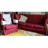 A Knowle Sofa of typical construction, together with a pair of Knowle wingback armchairs, circa