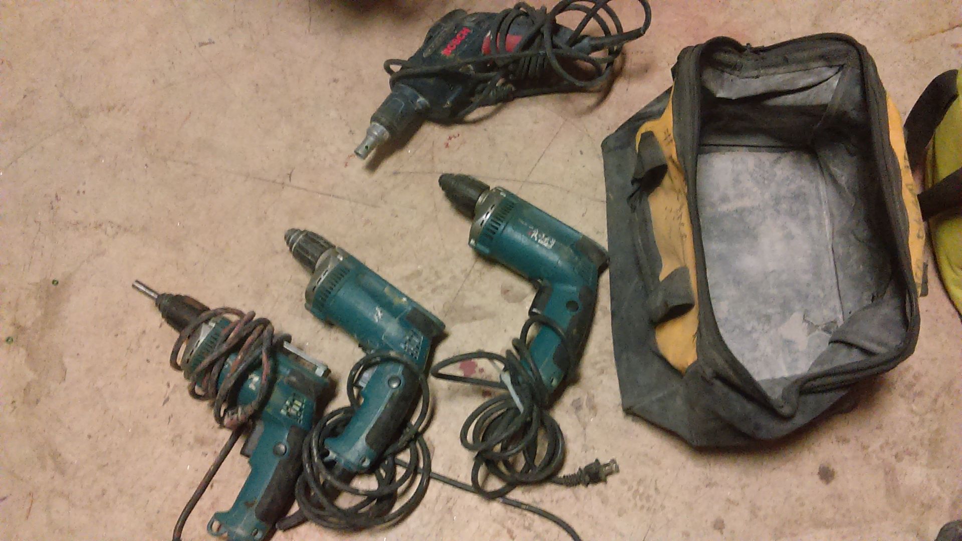 LOT OF: (1) BOSCH CORDED DRYWALL DRILL AND (3) MAKITA CORDED DRILLS --ALL IN DEWALT BAG