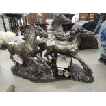 A modern resin study modelled as galloping horses with a bronzed finish and a pair of gold plated cu