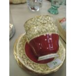 An Aynsley tea for two set in gilt and crushed raspberry