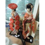 Two oriental dolls on stands, a fan A/F and unframed painting