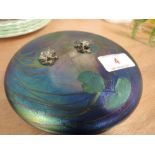 A John Ditchfield Glasform iridescent glass paperweight in the form of a lily pad with two silver