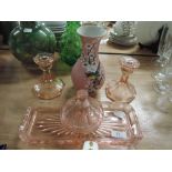 A pink glass dressing table tray, candlesticks and pot etc