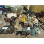 A selection of animal ornaments including donkeys, cattle and horses