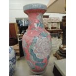 A large pink vase with floral design