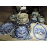 A shelf of blue and white tableware including Enoch Woods, Royal Staffordshire etc