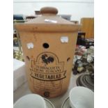 A terracotta vegetable storage crock