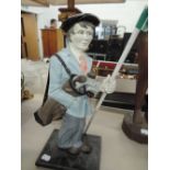 A cast door stop modelled as a golfer