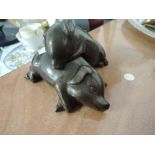 A pair of bronze effect pigs